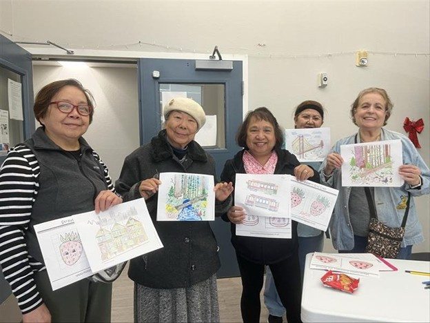 Seniors showing their artwork at a PEARLS group session