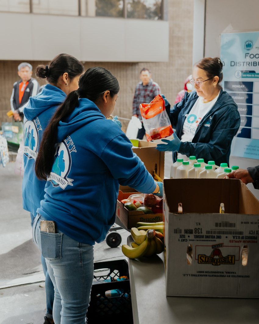 Volunteers sorting groceries at the weekly food distribution