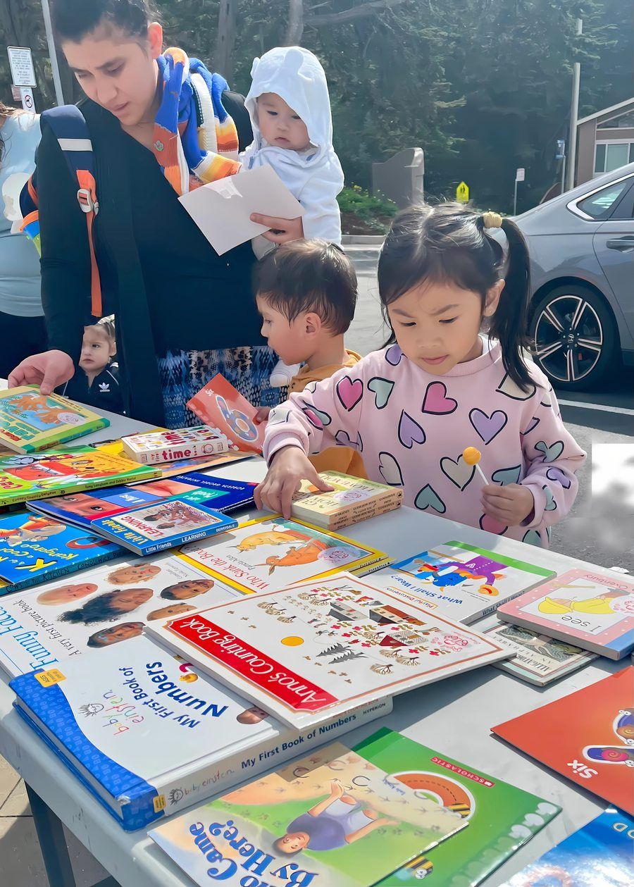 Kids choosing books at an Our Second Home event