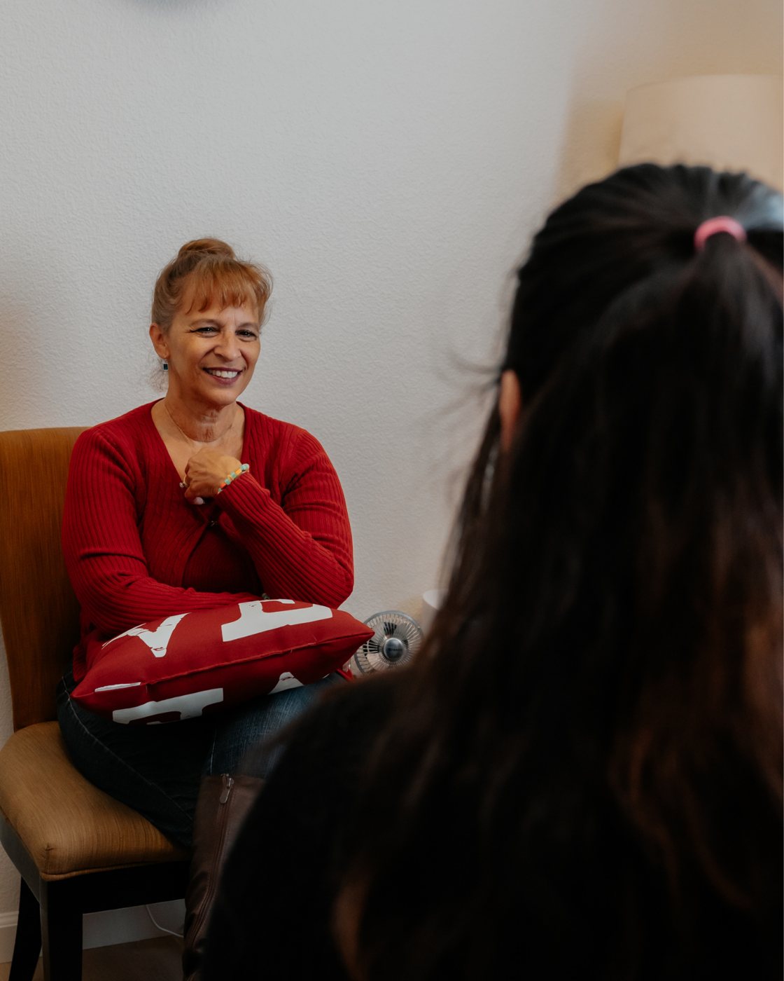 A therapist smiling with a client during a counseling session