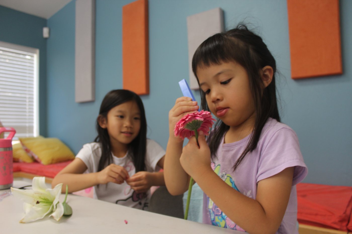 Two young students working on a flower craft at Our Second Home