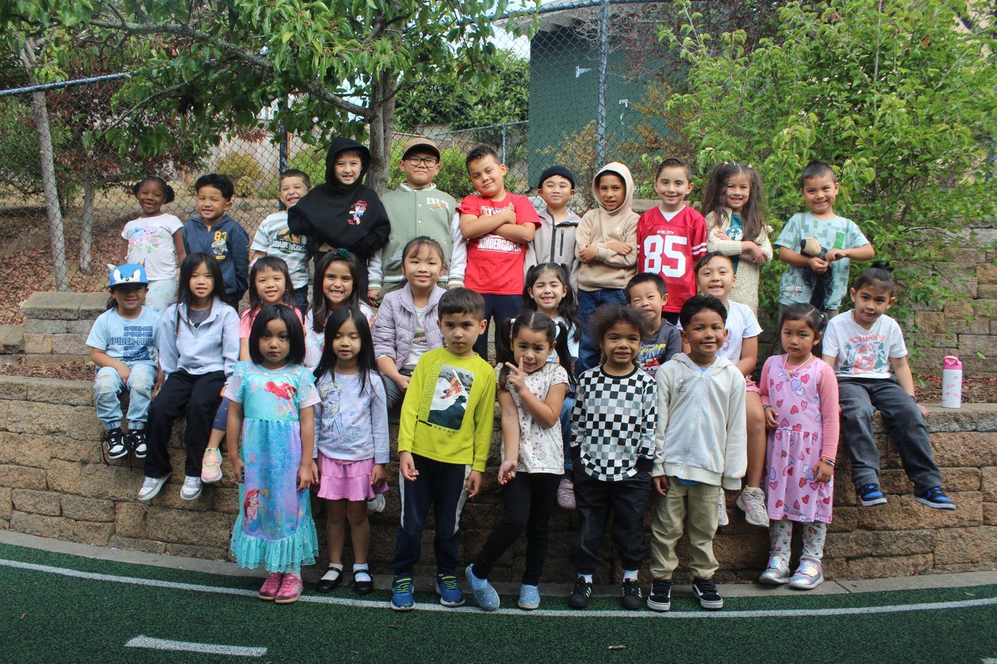 A smiling group of kids at an Our Second Home program