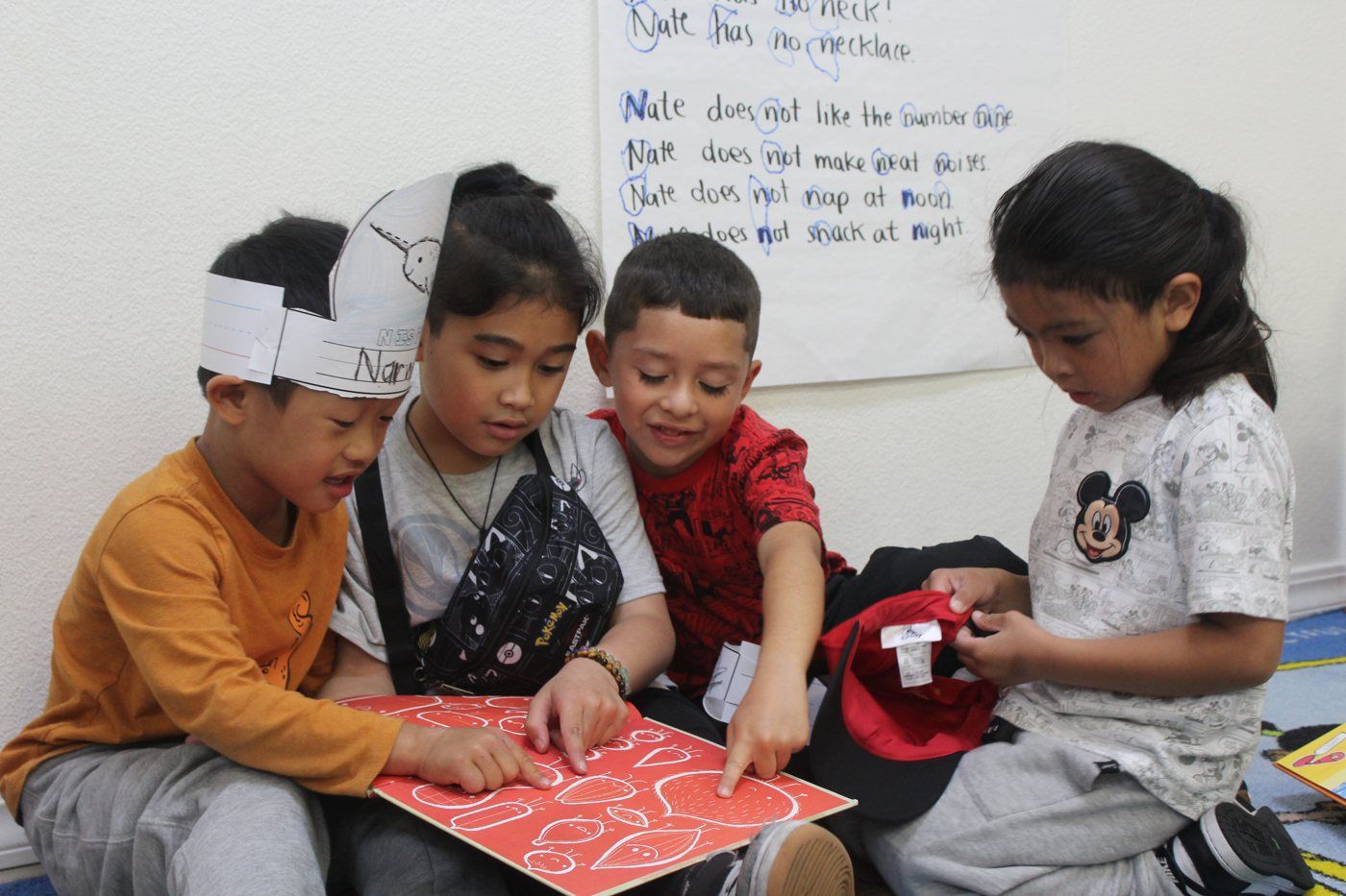 A small group of students reading a book together
