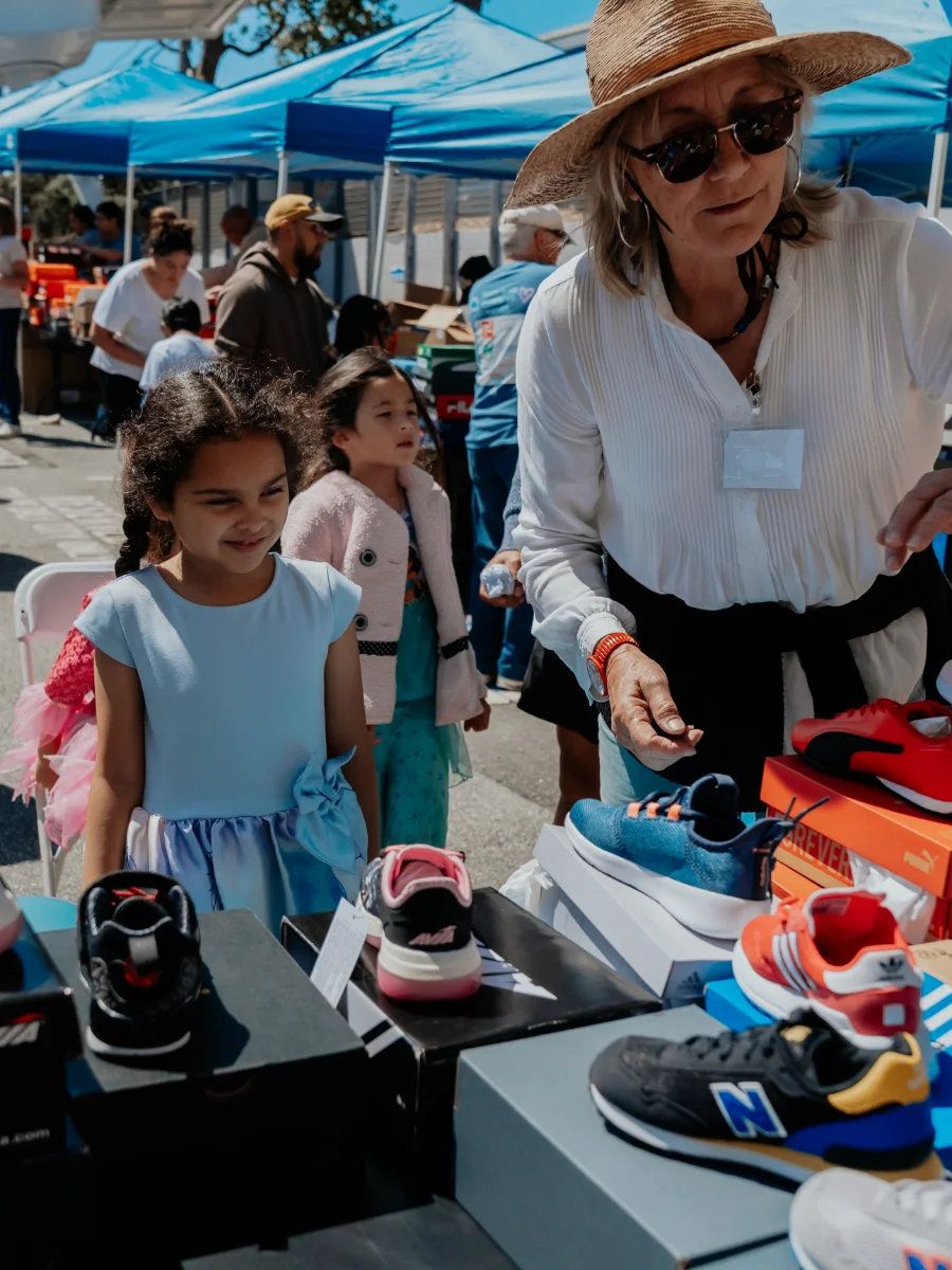 A child picking out new shoes at Family Resource Day, Summer 2025